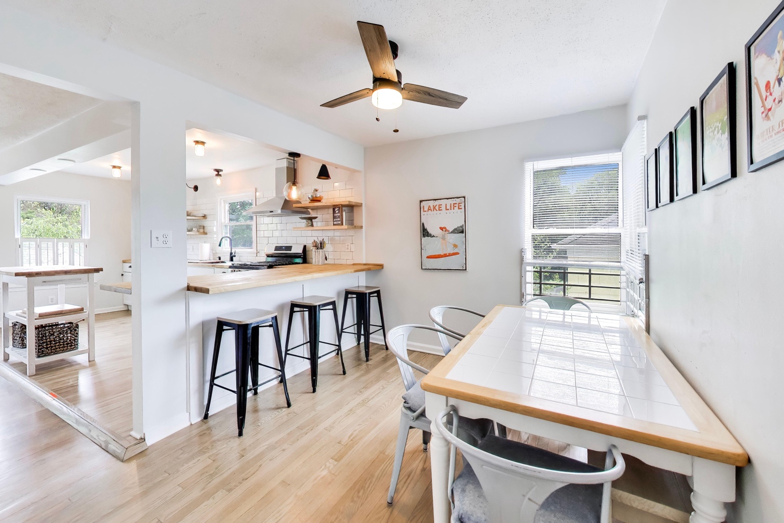 Dining area at Emmet’s Place with a white table beside the kitchen island